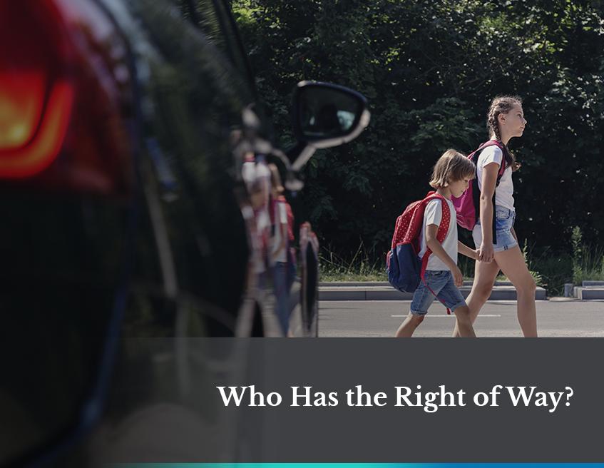 two kids walking across the street 